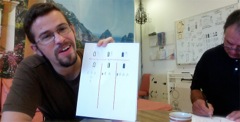 Adam shows a workbook for Handwriting practice